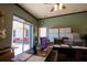 Bright home office features a large desk, computer, and sliding glass doors to the backyard at 300 Madrid Blvd, Punta Gorda, FL 33950