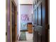 Bathroom hallway with light purple walls, dark brown doors, and teal rug at 300 Madrid Blvd, Punta Gorda, FL 33950