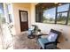 Relaxing screened porch with brick pavers, comfy seating, and view of the golf course at 300 Madrid Blvd, Punta Gorda, FL 33950