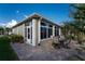 Outdoor patio with table and chairs, adjacent to the house at 24080 Buckingham Way, Punta Gorda, FL 33980