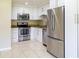 Modern kitchen with stainless steel appliances and white cabinets at 21150 Gertrude Ave # A3, Port Charlotte, FL 33952