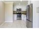 Bright kitchen features stainless steel appliances and granite countertops at 21150 Gertrude Ave # A3, Port Charlotte, FL 33952