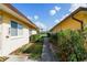 Walkway between two buildings with green landscaping on either side at 21150 Gertrude Ave # A3, Port Charlotte, FL 33952