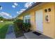 Exterior view of a building with a walkway and landscaping at 21150 Gertrude Ave # A3, Port Charlotte, FL 33952
