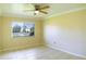 Bright bedroom with window, tile flooring and ceiling fan at 21150 Gertrude Ave # A3, Port Charlotte, FL 33952