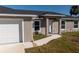 Front view of the house showcasing a walkway and attached garage at 11912 Brookside Ave, Port Charlotte, FL 33981