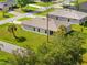 An aerial view of a backyard with a covered patio and lush green lawn at 1293 Preston St, Port Charlotte, FL 33952