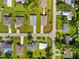 An overhead aerial view of a home in a residential neighborhood with well-manicured lawns at 1293 Preston St, Port Charlotte, FL 33952