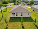 Aerial view of a backyard with a covered patio and well-manicured lawn at 1293 Preston St, Port Charlotte, FL 33952