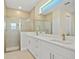 Modern bathroom featuring double sinks, white cabinetry, and a walk-in shower at 1293 Preston St, Port Charlotte, FL 33952