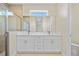 Bathroom with double sink vanity, white cabinets, and glass shower at 1293 Preston St, Port Charlotte, FL 33952