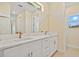 Bright bathroom with double vanity sinks and large mirror at 1293 Preston St, Port Charlotte, FL 33952