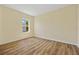 Bright bedroom with wood-look flooring and a large window overlooking the yard at 1293 Preston St, Port Charlotte, FL 33952