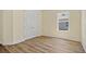 Bright bedroom featuring durable wood-look floors and a well-lit ambiance from a sunlit window at 1293 Preston St, Port Charlotte, FL 33952