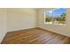 Inviting bedroom with durable wood-look floors, and a large window with a view of trees at 1293 Preston St, Port Charlotte, FL 33952