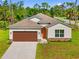 Charming single-story home featuring a two-car garage, landscaped front yard, and neutral color palette in a vibrant neighborhood at 1293 Preston St, Port Charlotte, FL 33952