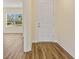 Inviting hallway featuring durable wood-look floors and a bright and airy ambiance at 1293 Preston St, Port Charlotte, FL 33952