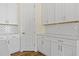 Kitchen with white cabinets, subway tile backsplash, and modern hardware at 1293 Preston St, Port Charlotte, FL 33952