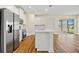 Modern kitchen featuring white cabinets, stainless steel appliances, and a center island open to the living area at 1293 Preston St, Port Charlotte, FL 33952