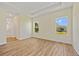 Bright main bedroom with tray ceiling, wood-look flooring, and backyard views at 1293 Preston St, Port Charlotte, FL 33952
