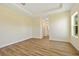 Spacious main bedroom with wood-look flooring, tray ceiling, and ensuite bathroom access at 1293 Preston St, Port Charlotte, FL 33952