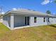 Backyard view of a single-Gathering home featuring a covered patio area at 1301 Preston St, Port Charlotte, FL 33952