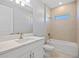 Elegant bathroom with a single vanity, large mirror, and bathtub with a tiled shower at 1301 Preston St, Port Charlotte, FL 33952