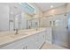 Bathroom featuring double vanity, quartz countertops, and glass shower at 1301 Preston St, Port Charlotte, FL 33952