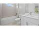 This bathroom features a single vanity, bath tub, and tiled shower, providing a modern look at 1301 Preston St, Port Charlotte, FL 33952
