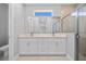 Bathroom featuring double vanity, large mirror, and glass-enclosed shower at 1301 Preston St, Port Charlotte, FL 33952