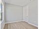 Bedroom with wood-look floors, neutral paint, bright light, and single door entry at 1301 Preston St, Port Charlotte, FL 33952