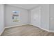 Bright bedroom features wood-look flooring and a closet, offering a comfortable living space at 1301 Preston St, Port Charlotte, FL 33952