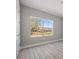 This bedroom features hardwood floors, a bright window, and a neutral color scheme at 1301 Preston St, Port Charlotte, FL 33952