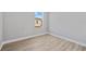 This bedroom features wood-look flooring and a bright window, with a neutral color scheme at 1301 Preston St, Port Charlotte, FL 33952