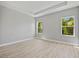 Bedroom with wood-look floors, neutral paint and two windows at 1301 Preston St, Port Charlotte, FL 33952