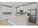 Modern kitchen featuring an island, stainless appliances and plank floors at 1301 Preston St, Port Charlotte, FL 33952