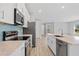 Kitchen featuring quartz countertops, stainless steel appliances and view to living area at 1301 Preston St, Port Charlotte, FL 33952