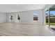 Bright living room with plank floors and slider door access to outside at 1301 Preston St, Port Charlotte, FL 33952