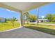 Covered patio with views of a lush yard and mature trees at 1301 Preston St, Port Charlotte, FL 33952