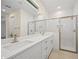 Stylish bathroom featuring double sink vanity, quartz counters, subway tile and walk-in glass shower at 1415 Nackman Rd, North Port, FL 34288