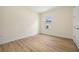 Cozy bedroom featuring wood-look flooring, light walls, and a window for ample natural light at 1415 Nackman Rd, North Port, FL 34288