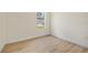 Cozy bedroom featuring wood-look flooring and a window for natural light at 1415 Nackman Rd, North Port, FL 34288