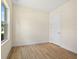 Bright bedroom with wood-look flooring, white walls and window with view to the yard at 1415 Nackman Rd, North Port, FL 34288