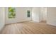 Spacious bedroom with wood floors, neutral walls, and large windows overlooking nature at 1415 Nackman Rd, North Port, FL 34288