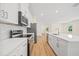Modern kitchen with white cabinets, quartz countertops, and stainless steel appliances at 1415 Nackman Rd, North Port, FL 34288
