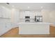 Modern kitchen featuring white cabinets, stainless steel appliances, and quartz countertops at 1415 Nackman Rd, North Port, FL 34288