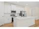 Modern kitchen featuring white cabinets, stainless steel appliances, and quartz countertops at 1415 Nackman Rd, North Port, FL 34288