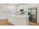 Modern kitchen with white cabinets, stainless steel appliances, and a large island at 1415 Nackman Rd, North Port, FL 34288