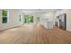 An open concept living room with wood floors, sliding glass doors, and modern fixtures at 1415 Nackman Rd, North Port, FL 34288