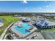 Aerial view of community pool, clubhouse, and tennis courts at 14271 Heritage Landing Blvd # 1526, Punta Gorda, FL 33955